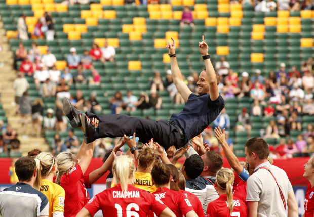 On a high: England hoist boss Mark Sampson as they celebrate victory over the Germans (Photo by Erich Schlegel / Action Images)