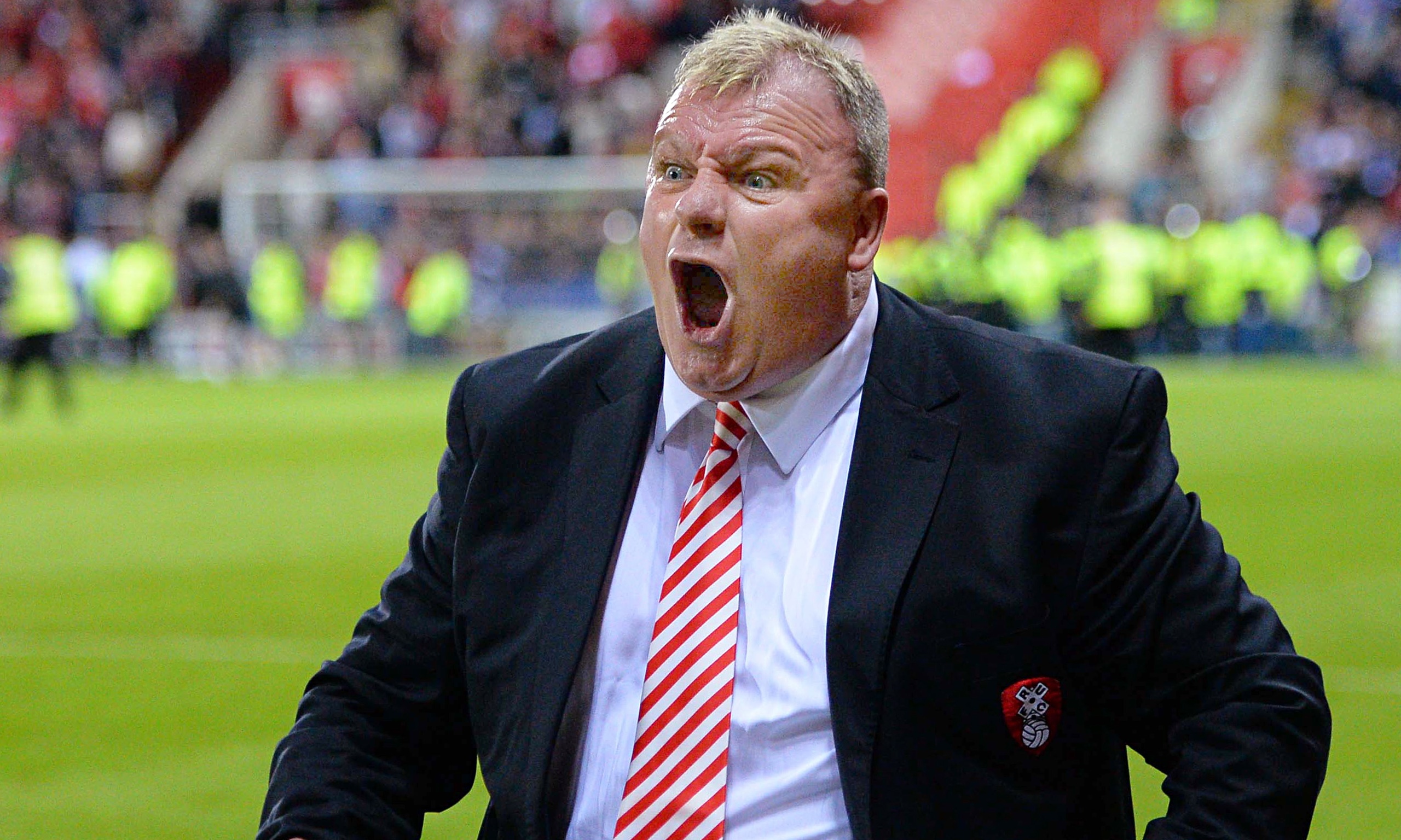 Rotherham manager Steve Evans appeals for fans to leave the pitch after they staged a premature pitc